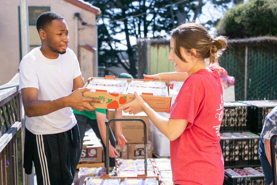 Image of volunteers handing out food.